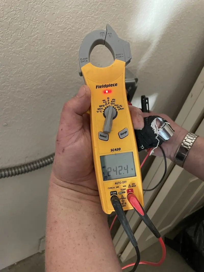 Voltage testing with clamp meter during Whole House Surge Protector in Gardere